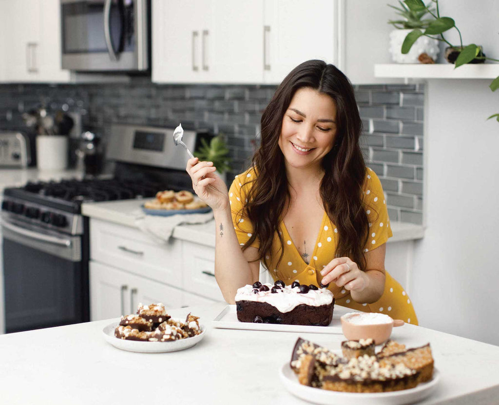 Lauren Toyota for Salt Spring Kitchen Company portrait in the kitchen eating chocolate desserts
