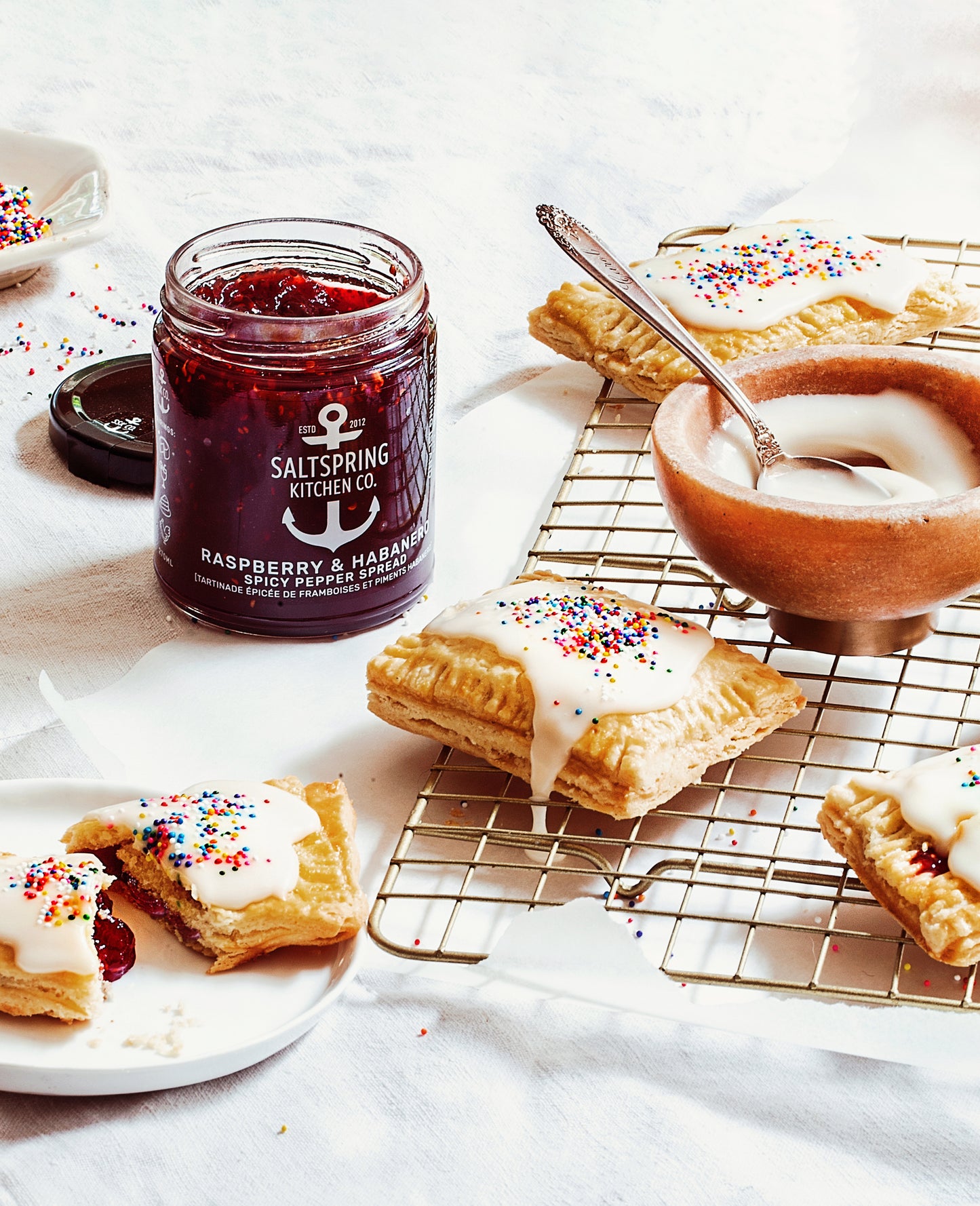 Saltspring Kitchen Company Raspberry Habanero Spicy Pepper Spread and Pop Tarts on a cooling rack with glaze