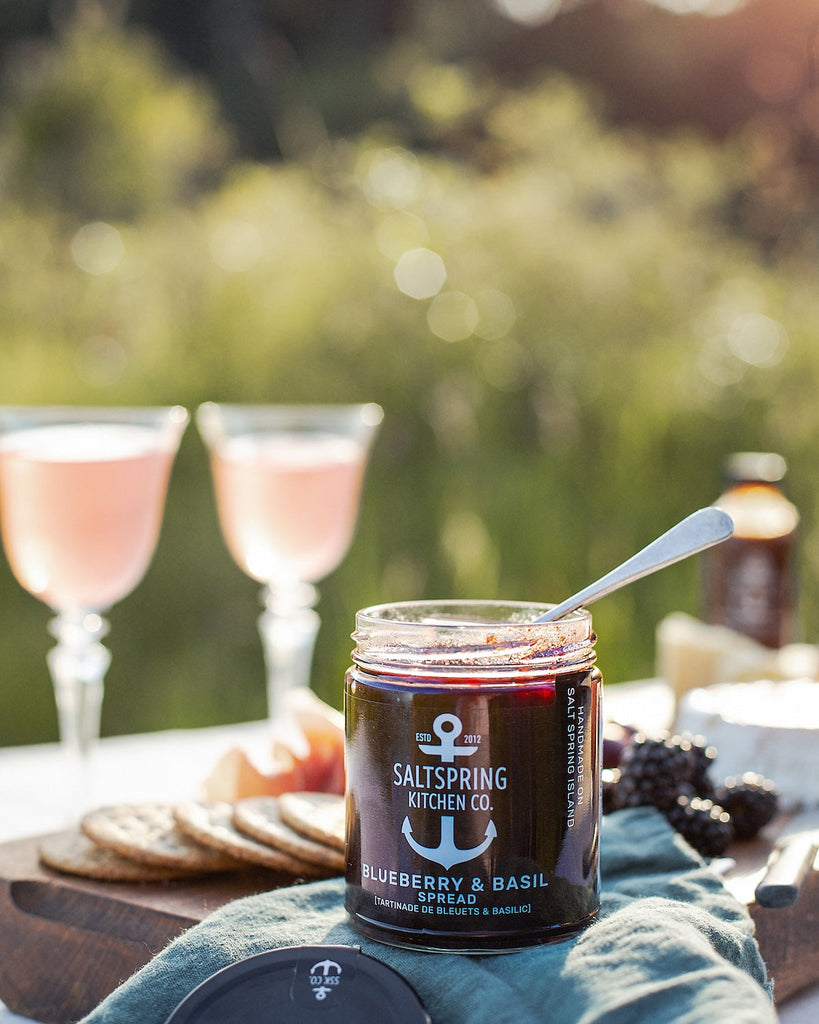 Salt Spring Kitchen Company Blueberry and Basil Spread on a table with crackers and cocktails