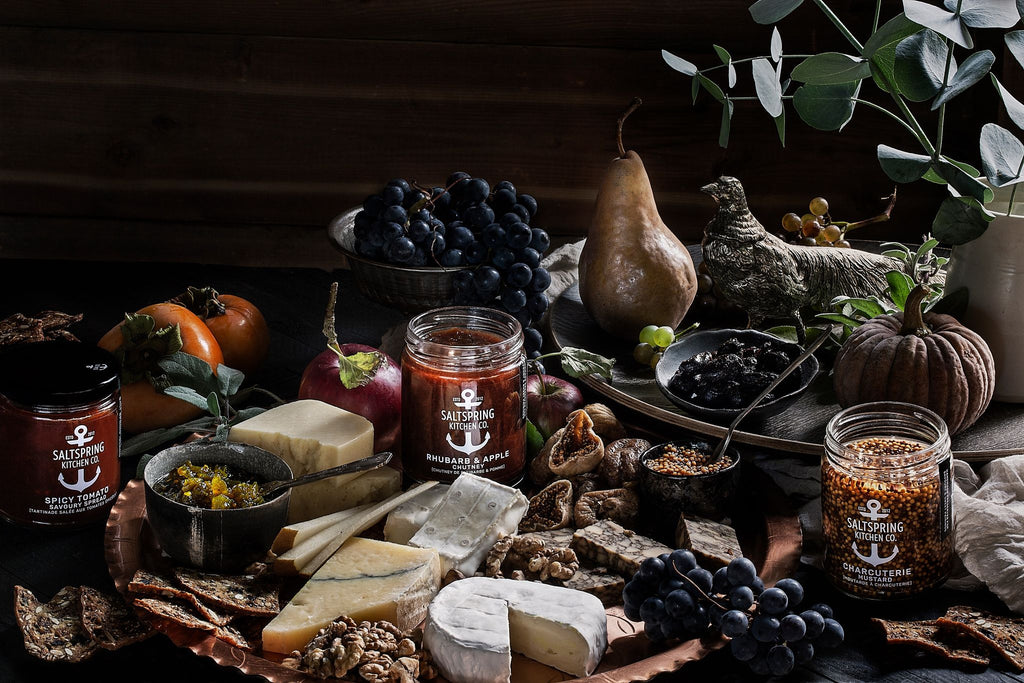 Salt Spring Kitchen Company dark spread with cheese and preserves on a table with fruit