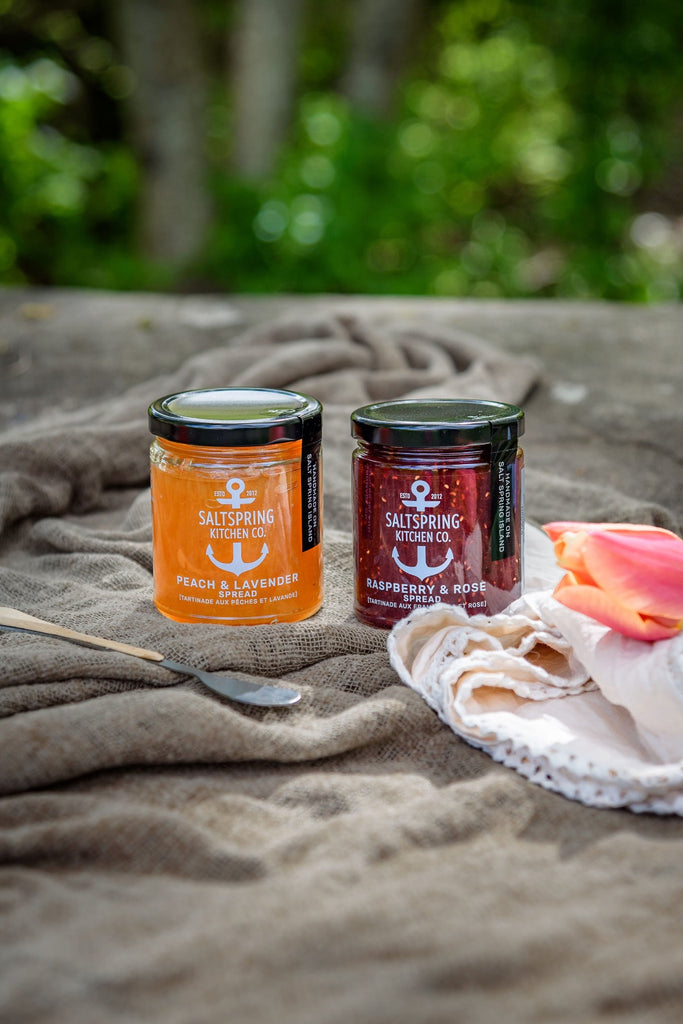 SaltSpring Kitchen Company Limited Edition Mother's Day Gift Boxes Peach and Lavender and Raspberry and Rose jam jars outside on a blanket