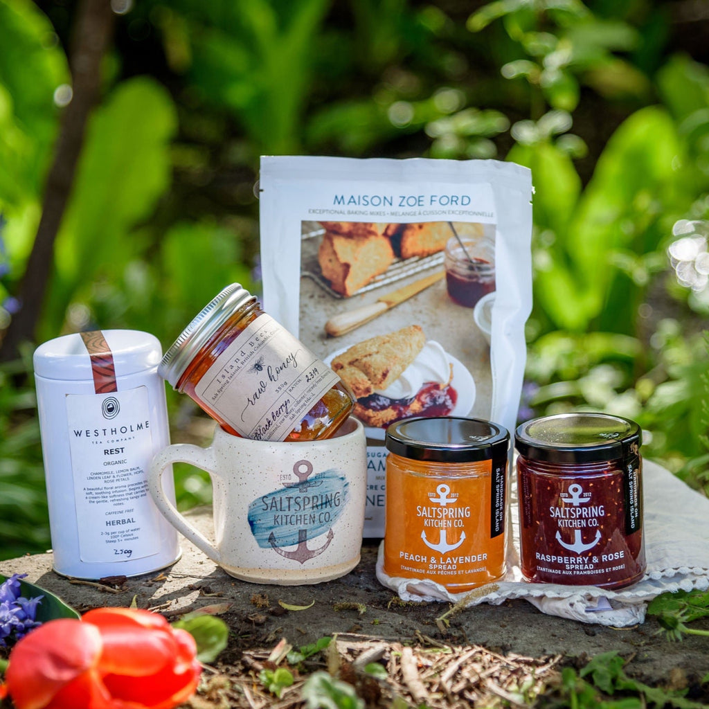 SaltSpring Kitchen Company Limited Edition Mother's Day Gift Boxes_Scones and a caramic mug with jams and tea and honey outside with flowers