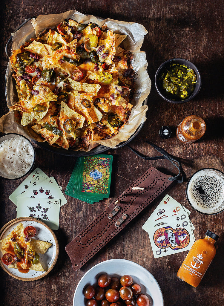 Salt Spring Kitchen Company Pineapple Turmeric Achiote Hot Sauce and Morita Hot Sauce with nachos on game night
