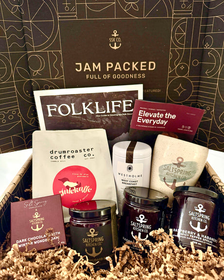 Gift basket with various products including coffee and jams, branded with 'Folklife' and 'drumroaster coffee co'.